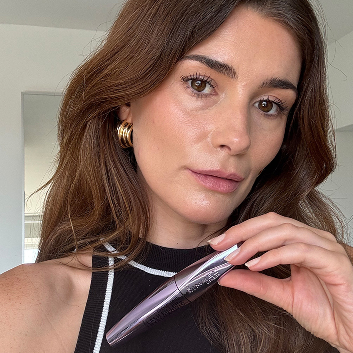 Eleanor taking a photo wearing the Rimmel Wonderbond mascara