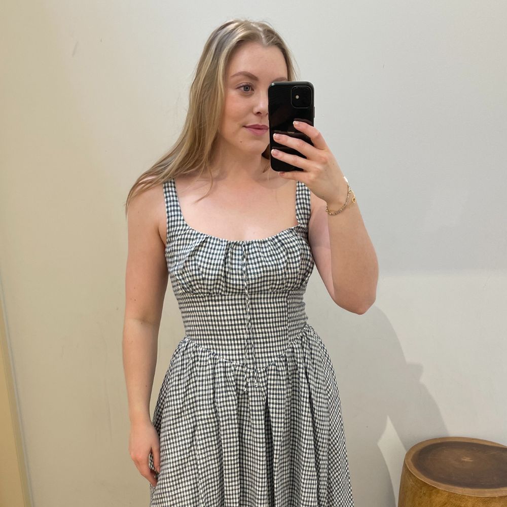 Woman wears gingham linen dress